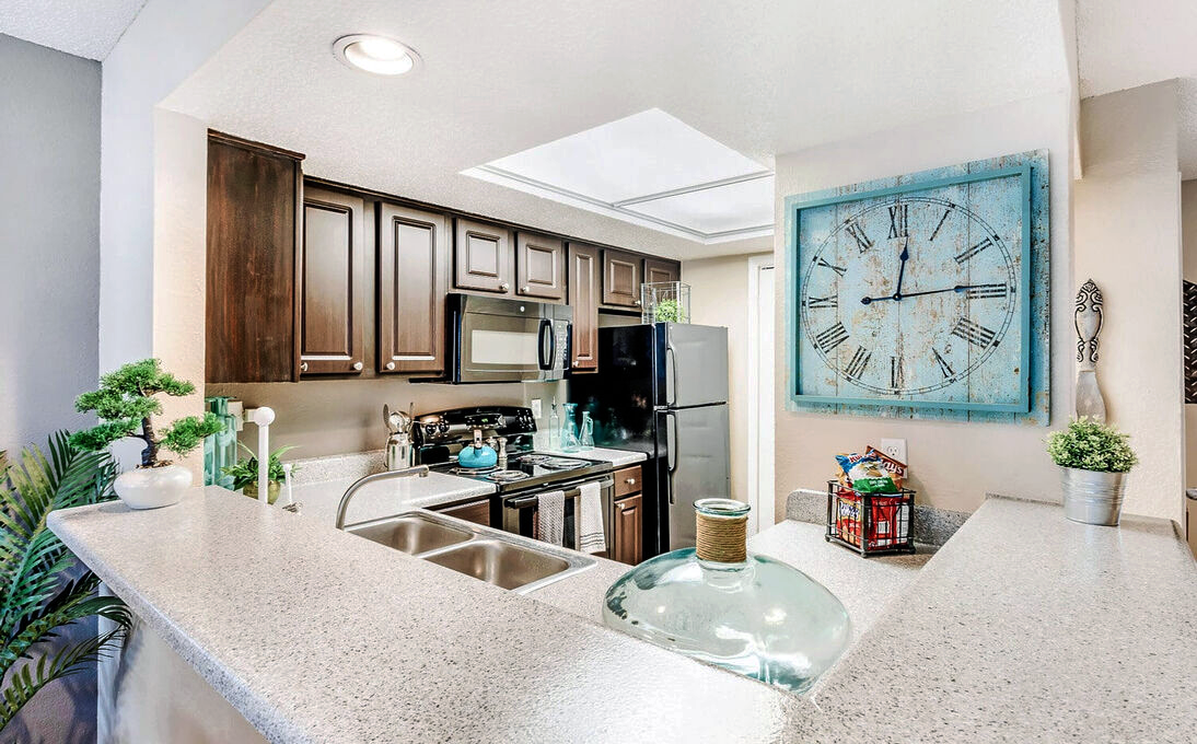 a kitchen with a large clock on the wall at The  Monte