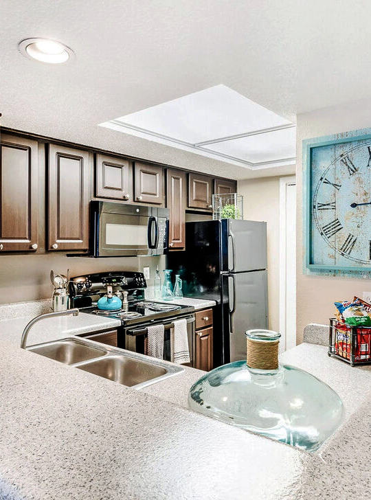 a kitchen with a large clock on the wall at The  Monte