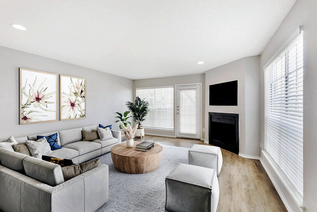 a living room with a couch, coffee table and television at The  Monte