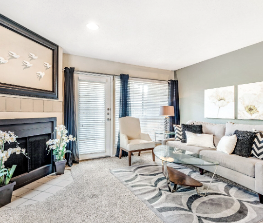 a living room with a fireplace and a couch at The Landmark At Gleneagles