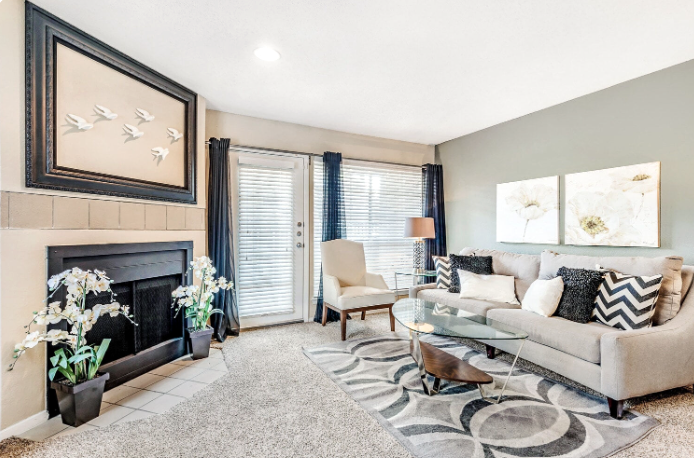 a living room with a fireplace and a couch at The Landmark At Gleneagles