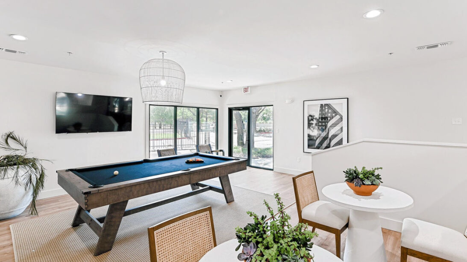 pool table in a living room with white furniture at The Landmark At Gleneagles