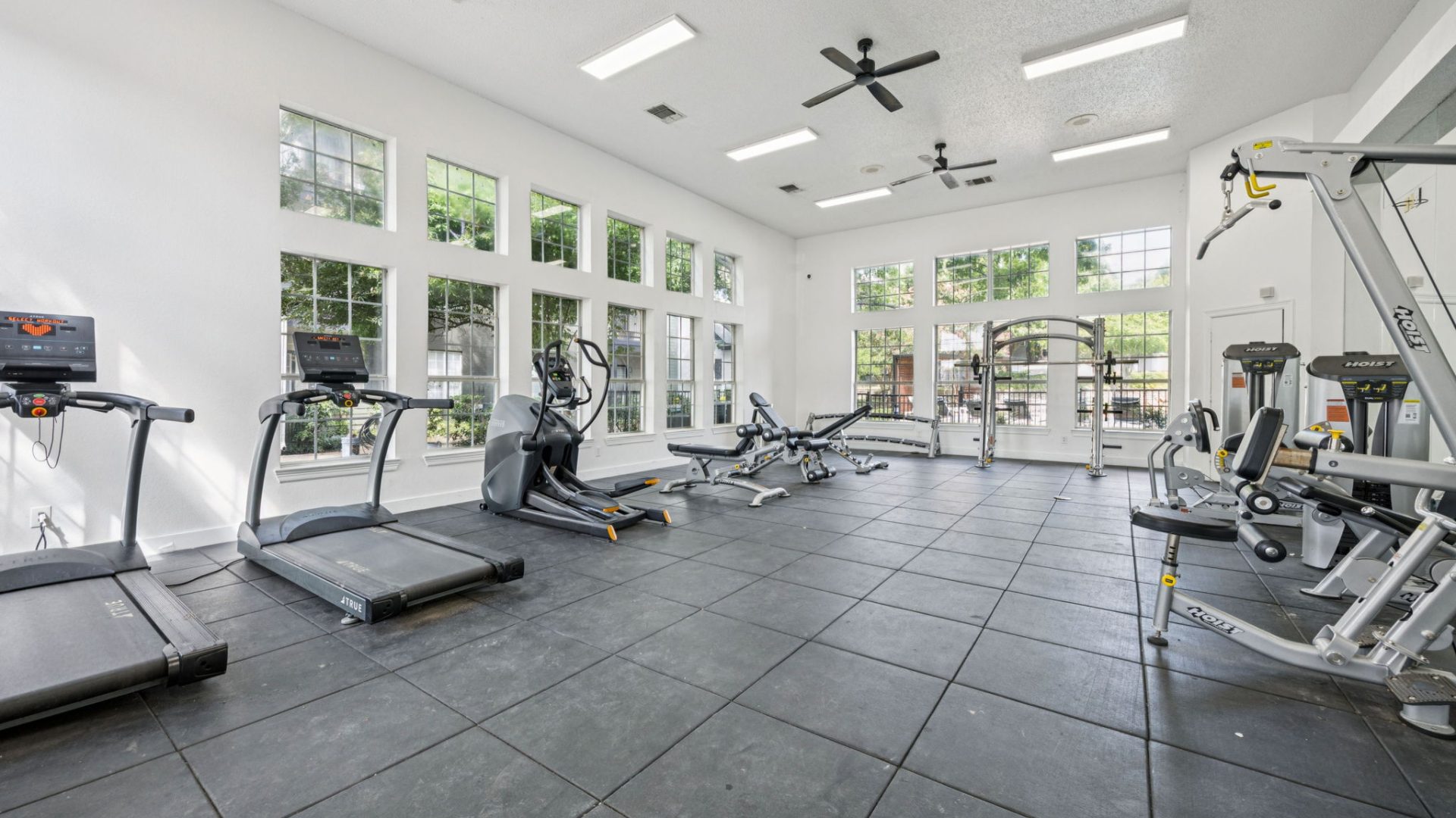 a gym room with treadmills and other equipment at The  Monte