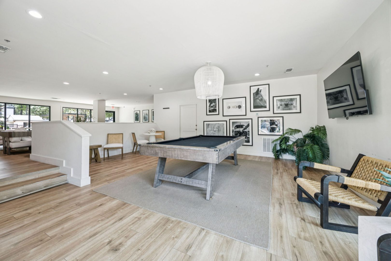 a pool table in a living room with a couch and chairs at The  Monte