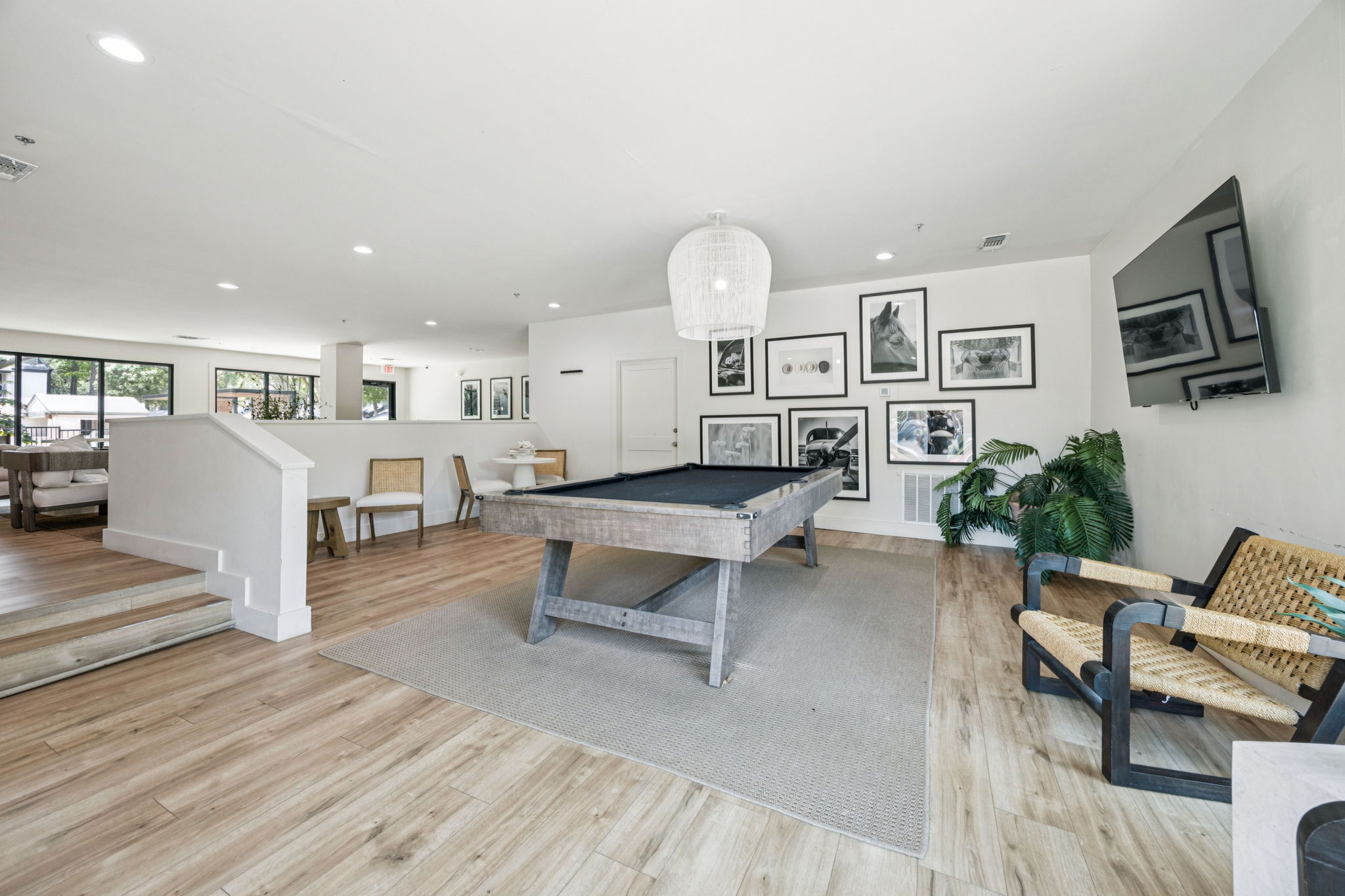 a pool table in a living room with a couch and chairs at The Monte
